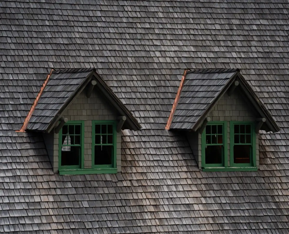 Dormers on a shingle roof in Utica, NY, where step flashing and kickout flashing carry water past the walls