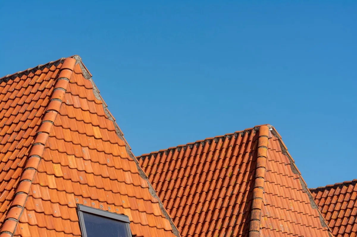 Clay barrel tile rooflines on homes in Utica, NY